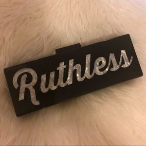 Milan blocks “Ruthless” acrylic clutch